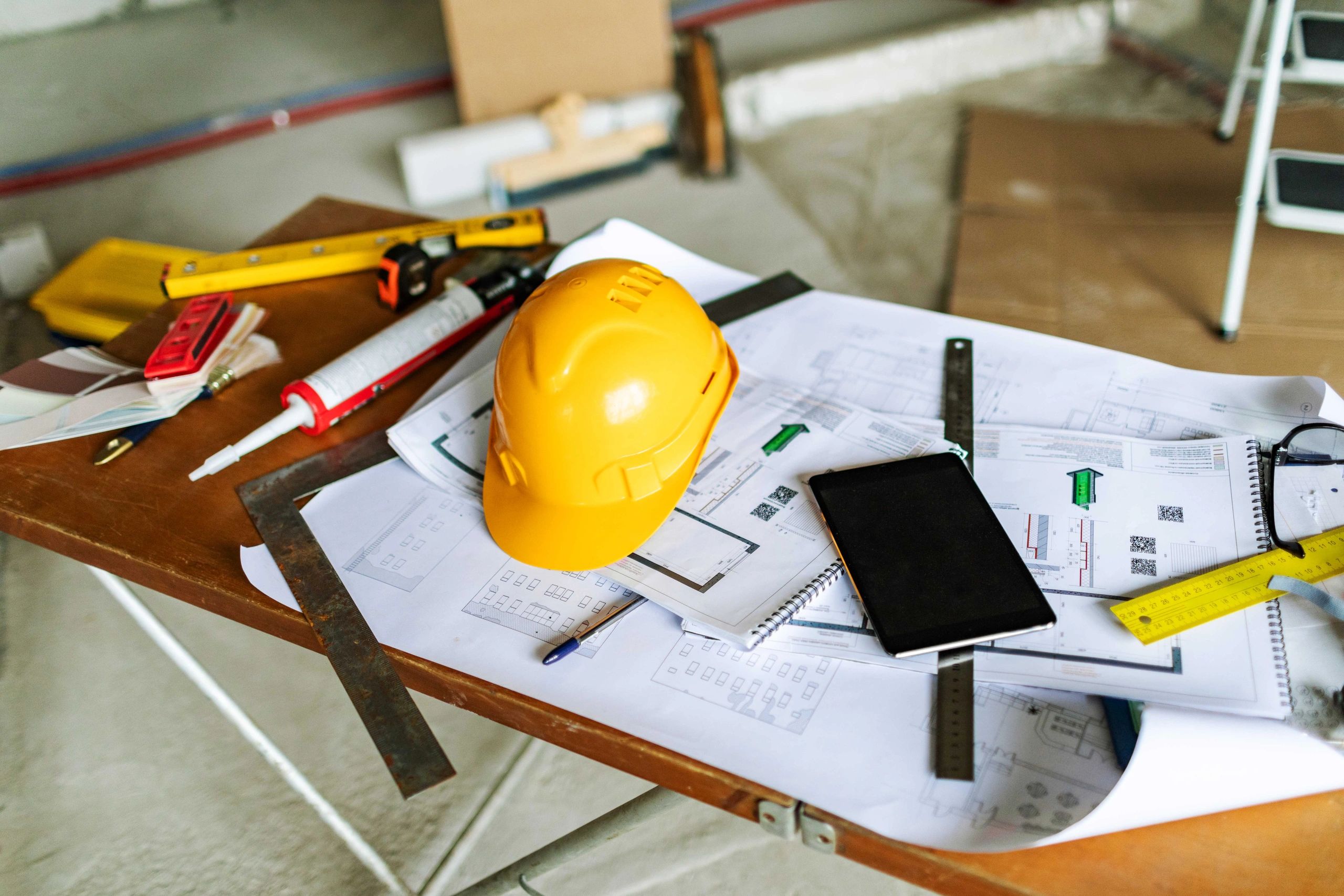 Blueprints and tools representing plumbing and public health design